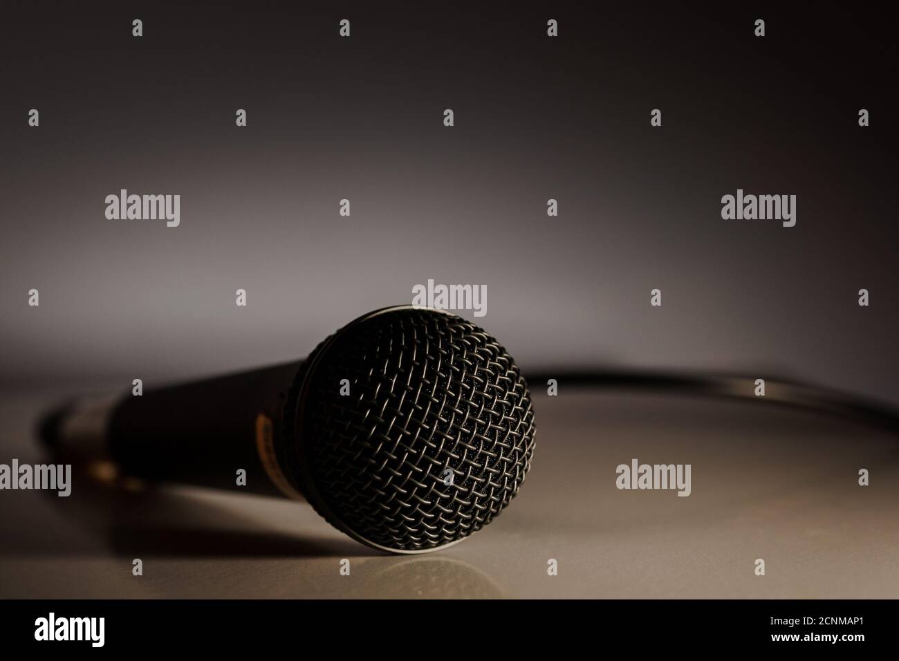 Microphone plugged in with wire on the ground in dramatic lighting