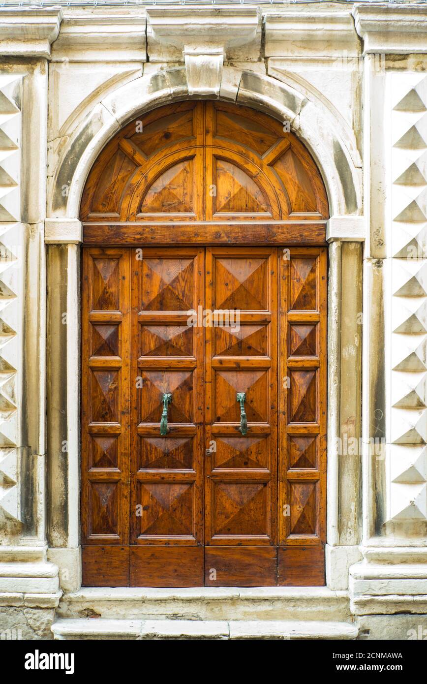 Fano, Marche, Italy, summer, wooden door, massive, historical, double-leaf, with metal fittings Stock Photo