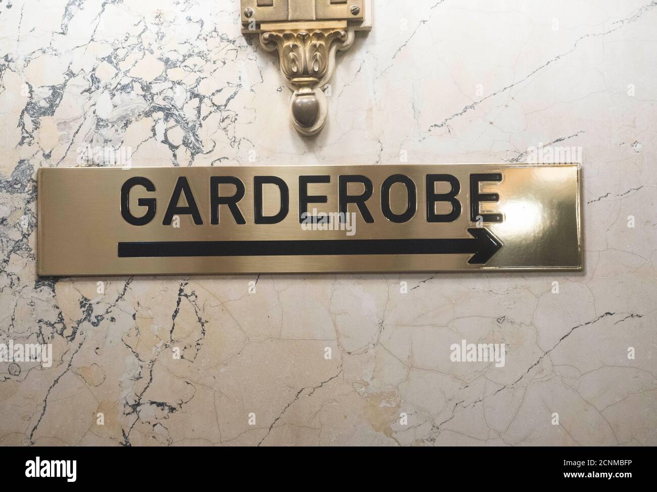 a golden german wardrobe (Garderobe) sign with a direction arrow Stock  Photo - Alamy