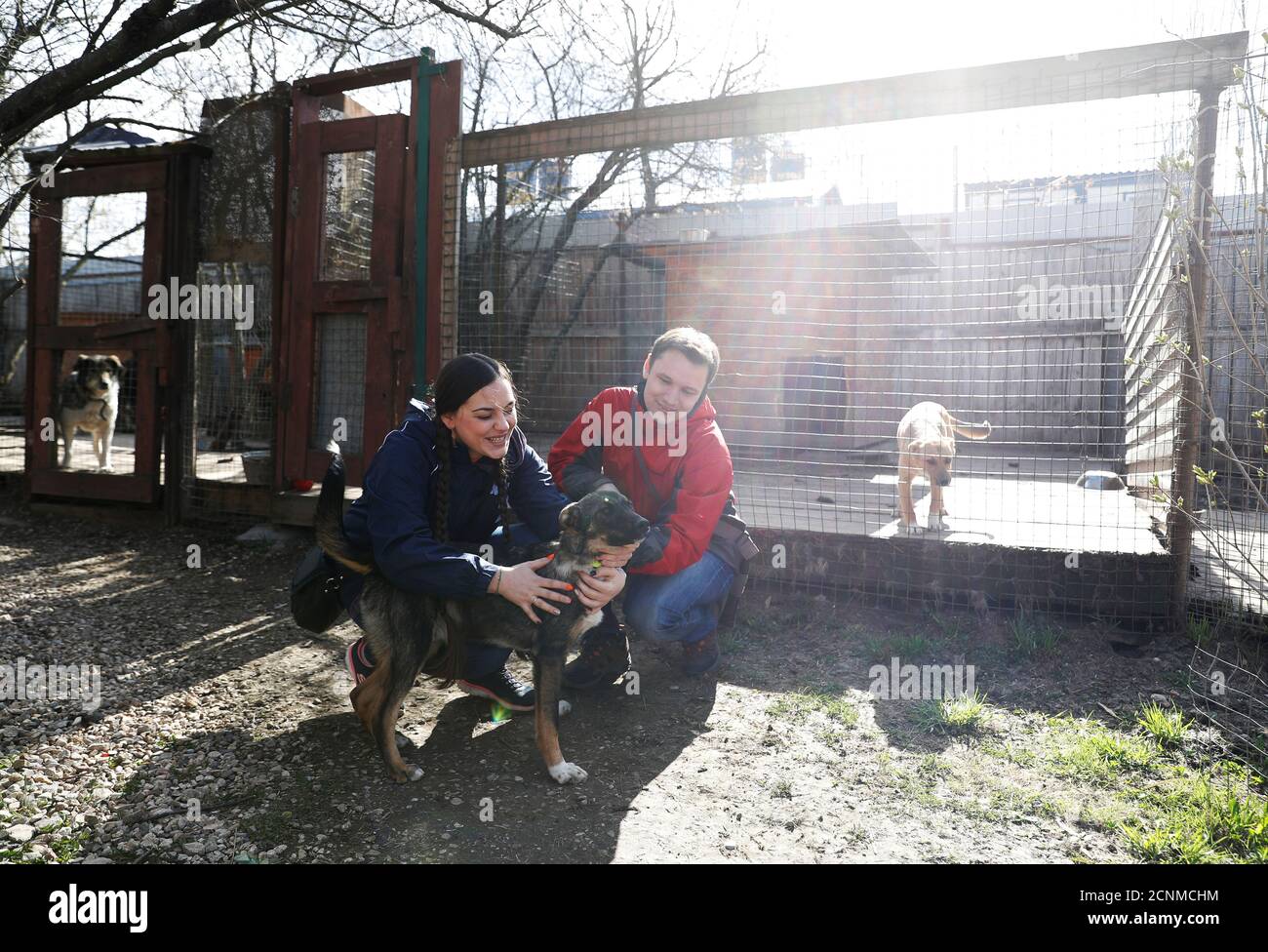 Maria Basova and her husband Alexander stroke Willy the dog before taking him home from an animal shelter in the town of Odintsovo in Moscow region, Russia April 29, 2020. Volunteers from Maria Basova and her husband Alexander stroke Willy the dog before taking him home from an animal shelter in the town of Odintsovo in Moscow region, Russia April 29, 2020. Volunteers from