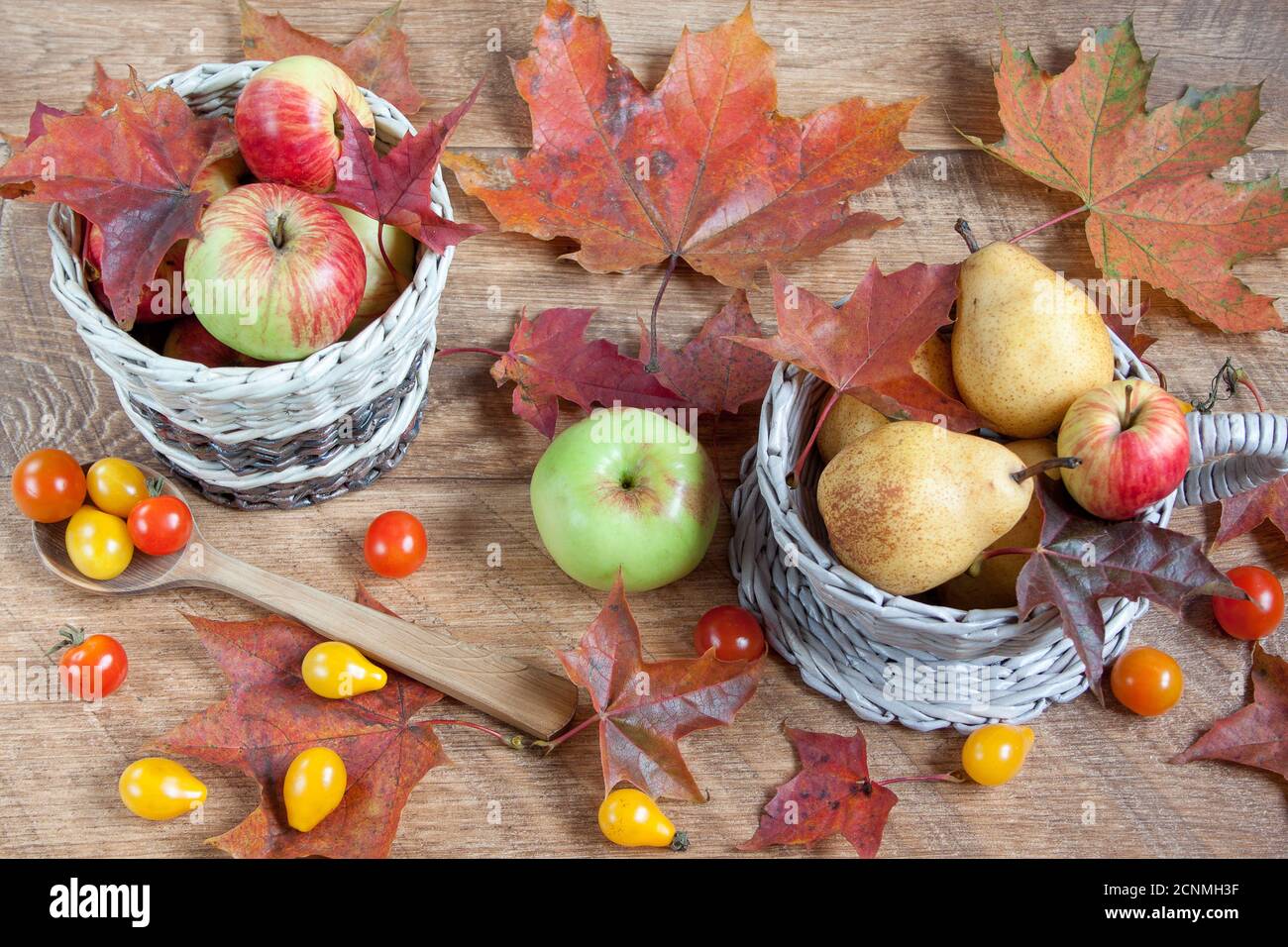 Autumn still life. Various vegetables and fruits are lying on wooden ...