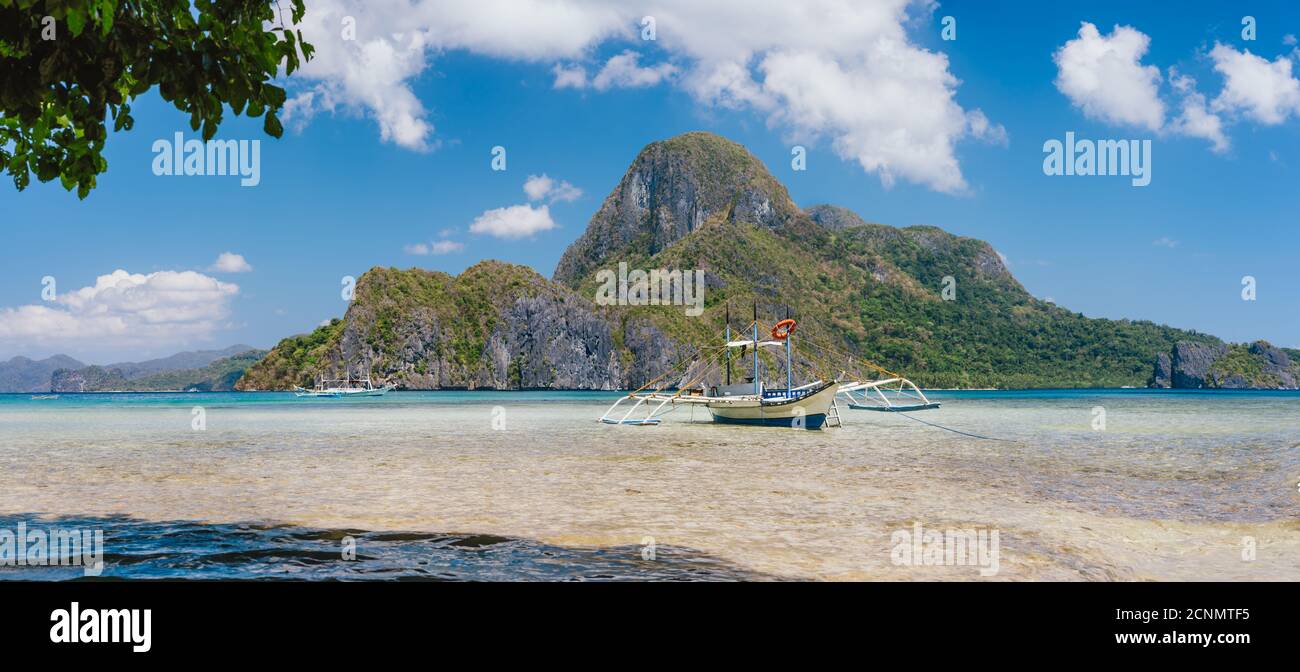 El Nido bay with trip boat and Cadlao island, Palawan, Philippines. Panoramic view. Stock Photo