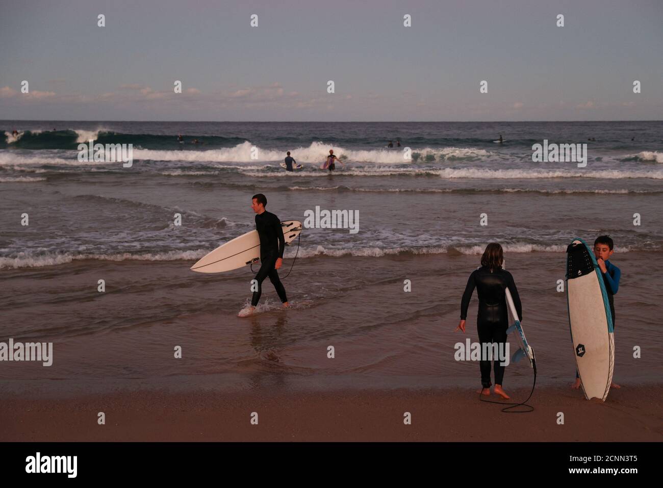 Surfers take to the water amidst the easing of restrictions implemented to curb the spread of the coronavirus disease (COVID-19) at Maroubra Beach in Sydney, Australia, May 11, 2020.  REUTERS/Loren Elliott Stock Photo