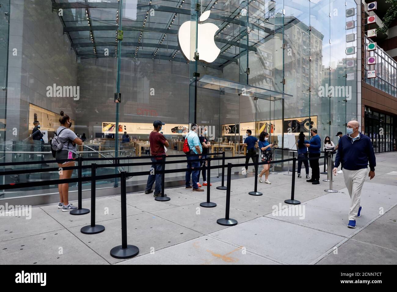 Customers distance before entering an Apple Store during phase one of reopening after the COVID-19 lockdown in New York City, New York, U.S. June 17, 2020. REUTERS/Brendan McDermid Stock Photo