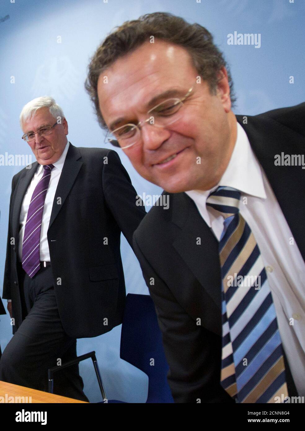 German Interior Minister Hans-Peter Friedrich (R) and President of the German Football Association (DFB),Theo Zwanziger, arrive at a news conference after a round table on violence during and after soccer matches, in Berlin November 14, 2011.  REUTERS/Thomas Peter (GERMANY - Tags: POLITICS SPORT SOCCER) Stock Photo