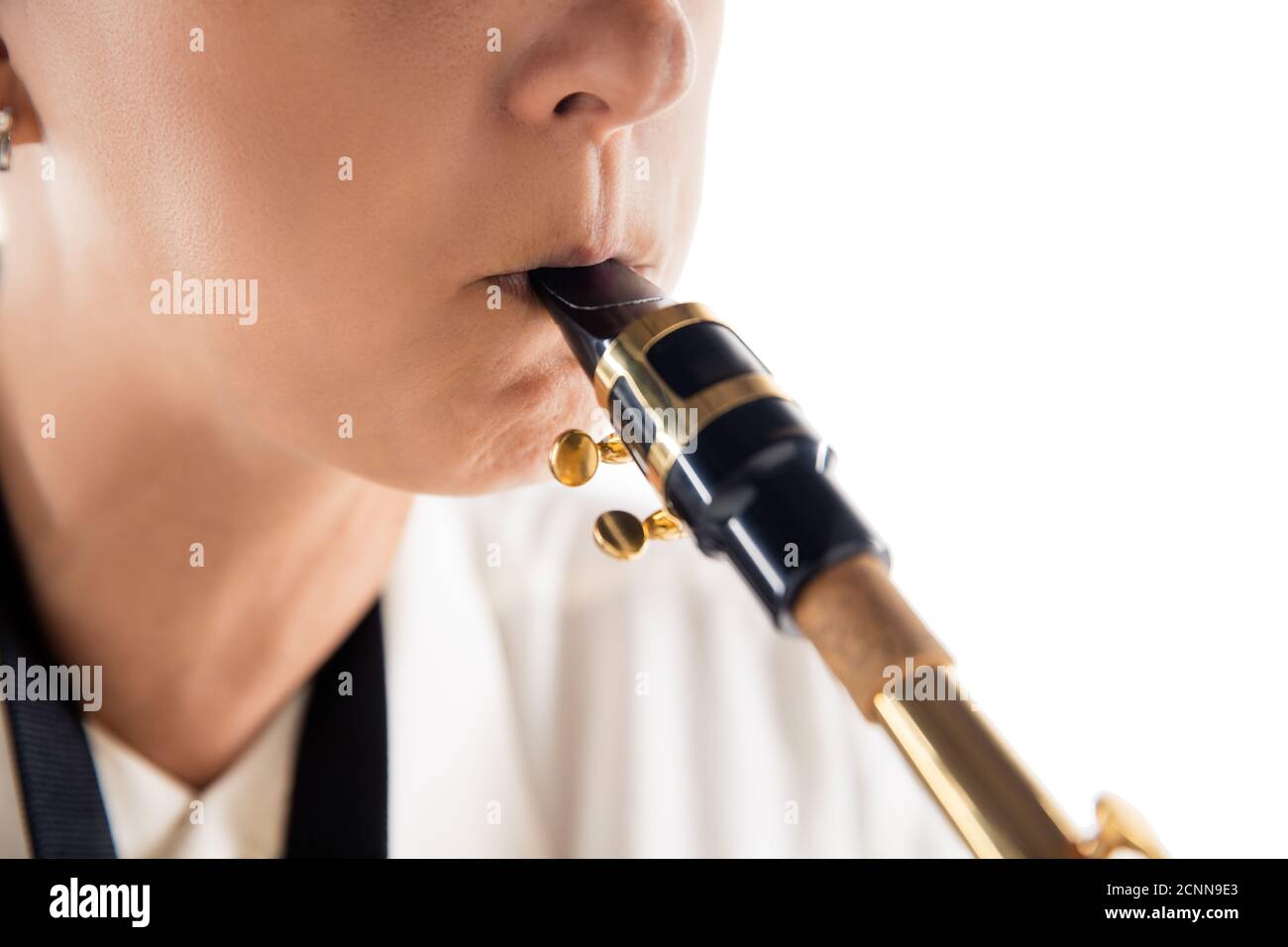 Close up woman playing saxophone isolated on white studio background. Inspired musician, details of art occupation, world classic instrument for jazz and blues. Concept of hobby, creativity. Stock Photo