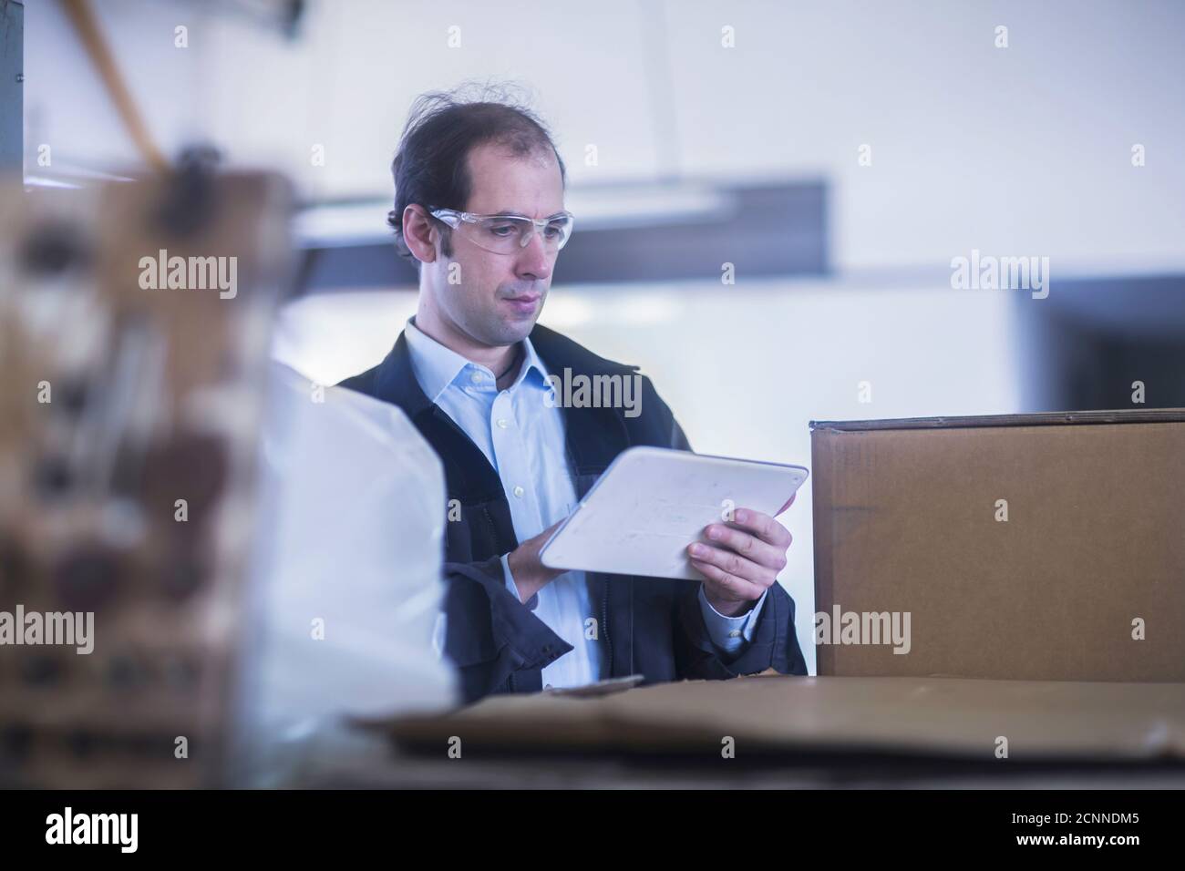 Engineer using a digital tablet in a factory, Germany Stock Photo