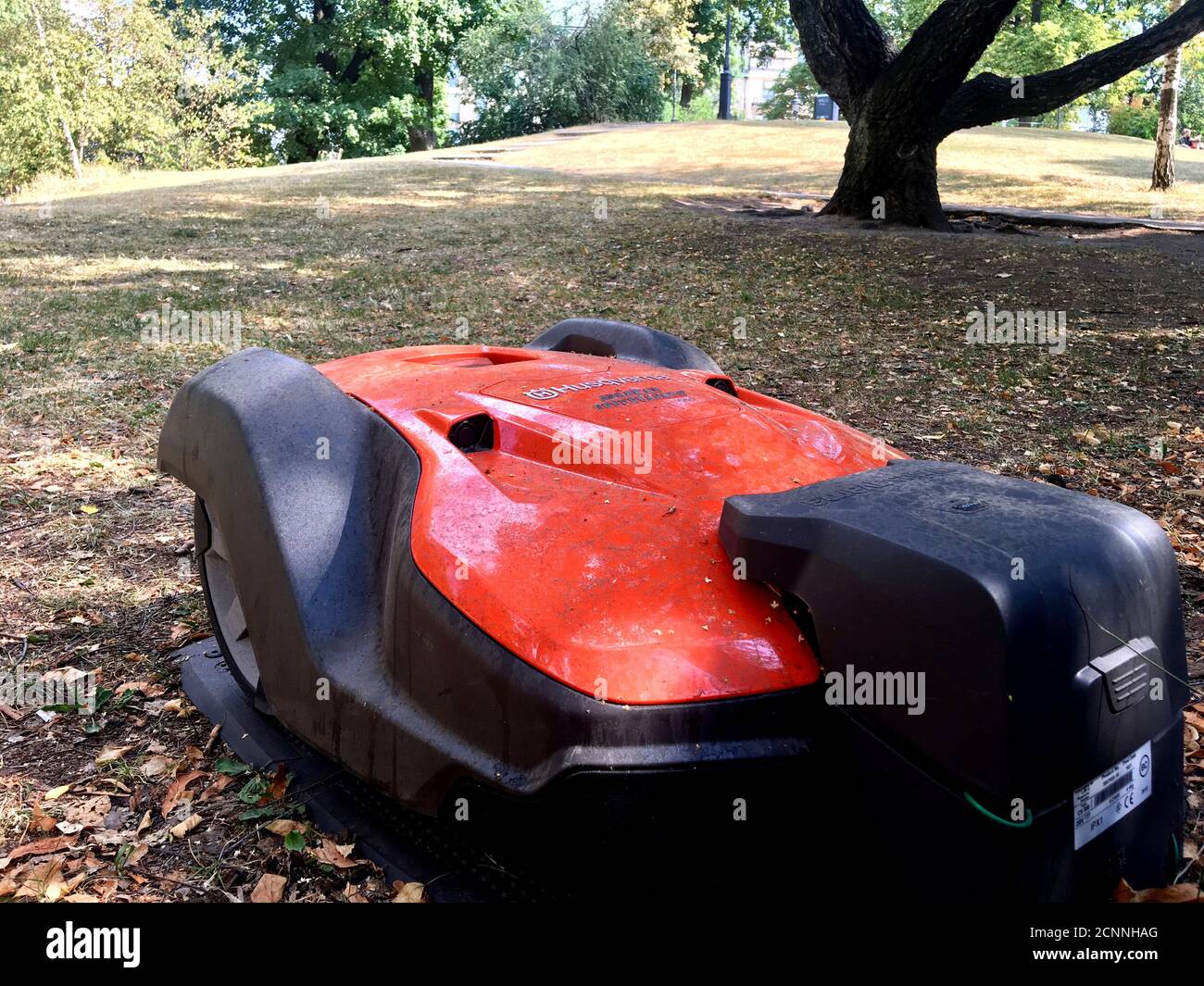 A Husqvarna robotic lawn mower is placed in its docking station in the Humlegarden park in Stockholm, Sweden July 21, 2018. Picture taken July 21, 2018. REUTERS/Anna Ringstrom Stock Photo