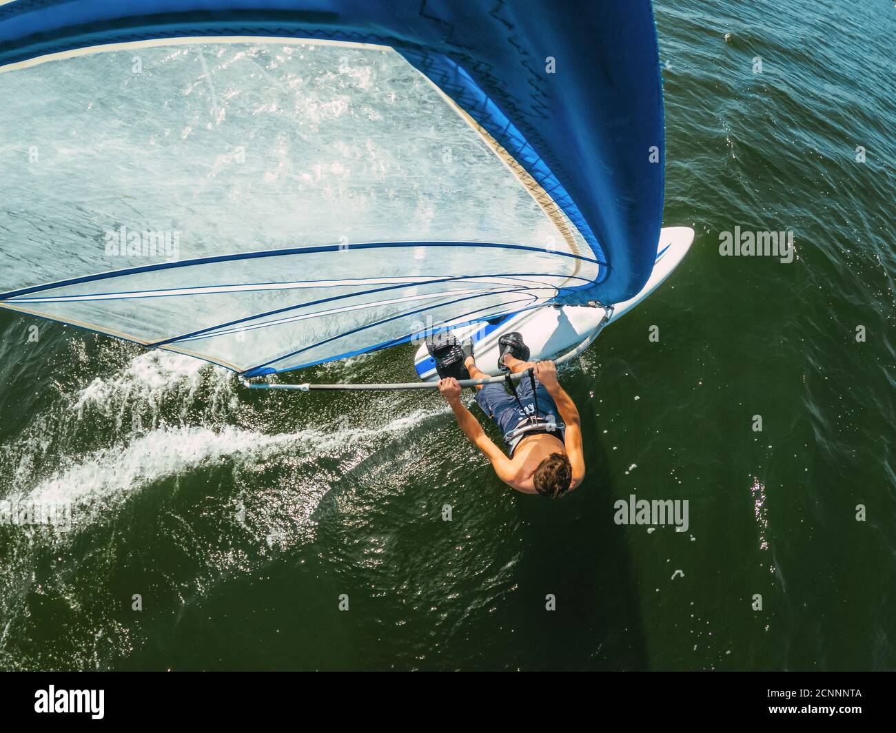 Man windsurfing on lake Wallersee, Flachgau, Salzburg, Austria Stock