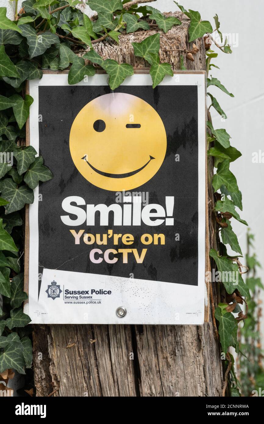 Sign reading Smile you're on CCTV with a smiley face. Security notice Stock Photo