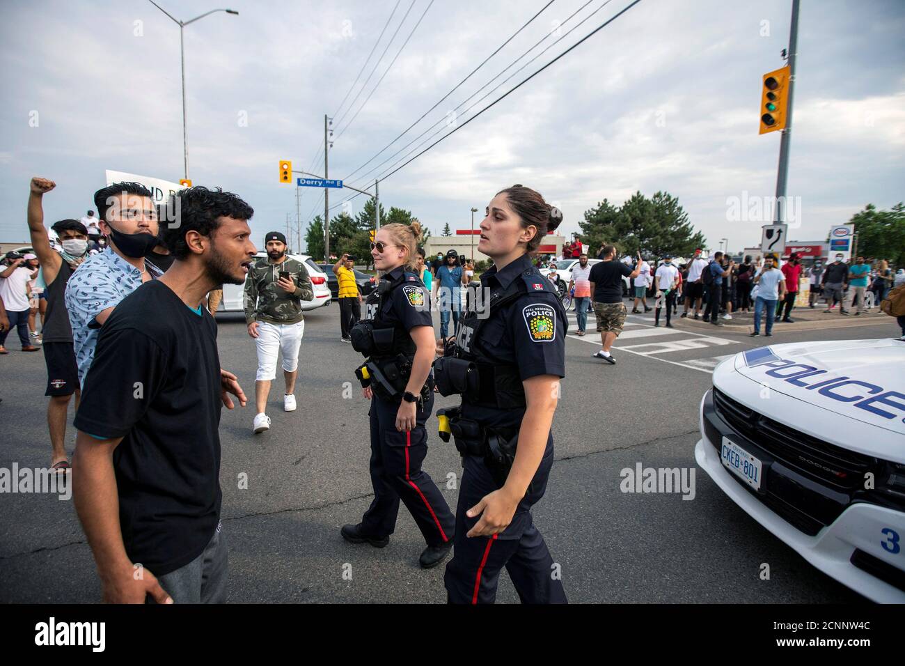 Protestors vent at police while demonstrating against the June 20 shooting death by Peel Regional Police of Ejaz Ahmed Choudry, 62, who family members say suffered from schizophrenia in Malton, Ontario, Canada June 22, 2020.  REUTERS/Carlos Osorio Stock Photo
