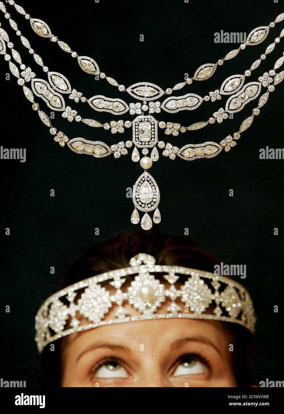 A model wears a Cartier diamond and pearl bandeau, estimated to sell for  $150,000 - $200,000, beneath a Cartier pendant necklace, estimated to sell  for $800,000 - $1,200,000, both owned by billionaire