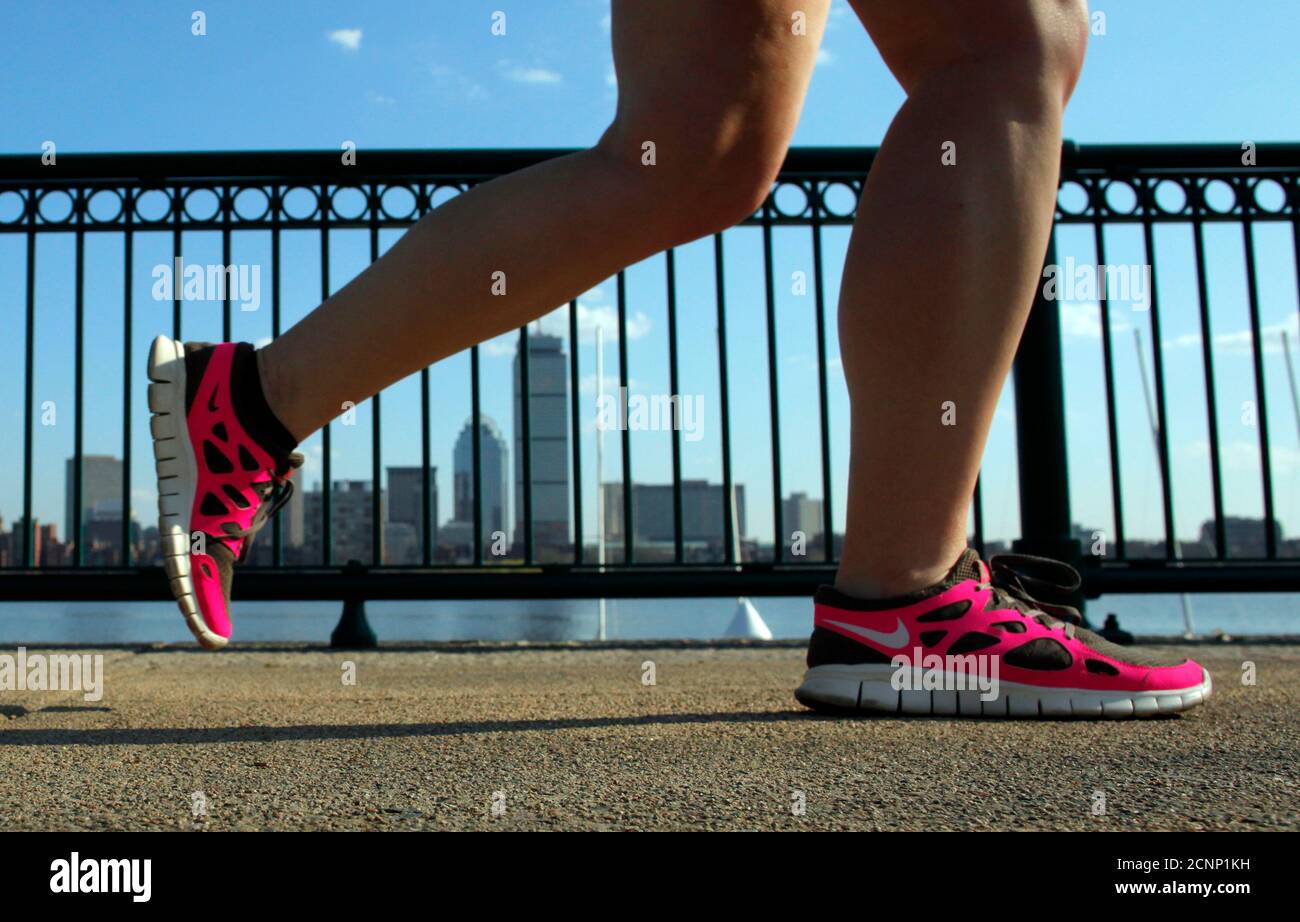 A jogger wearing Nike shoes runs along the Charles River in Cambridge,  Massachusetts March 20, 2012. Nike, Inc. plans to release its third quarter  fiscal 2012 financial results on March 22. REUTERS/Brian