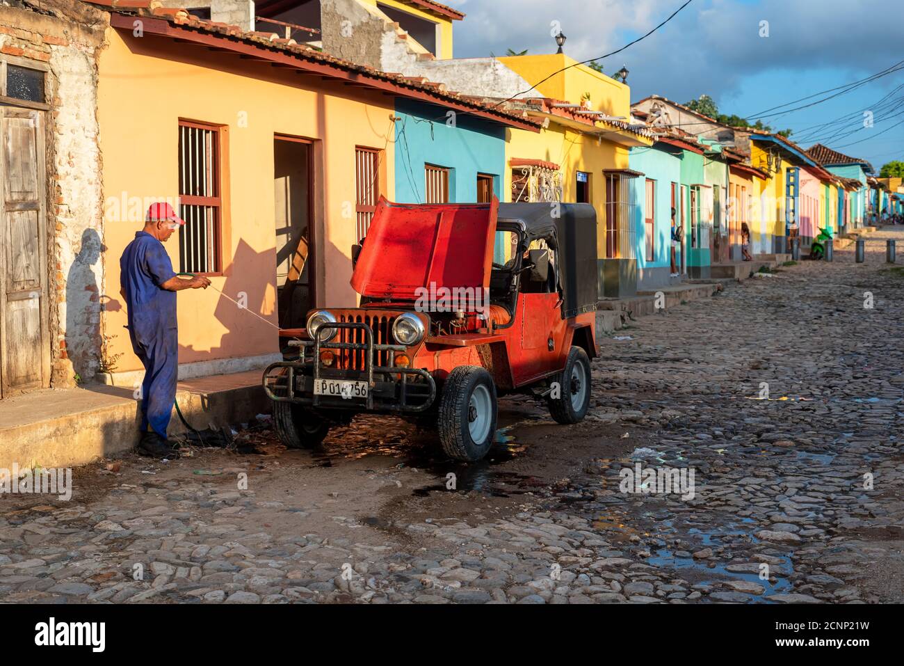 August 24, 2019: Man cleaning old Car. Trinidad, Cuba Stock Photo