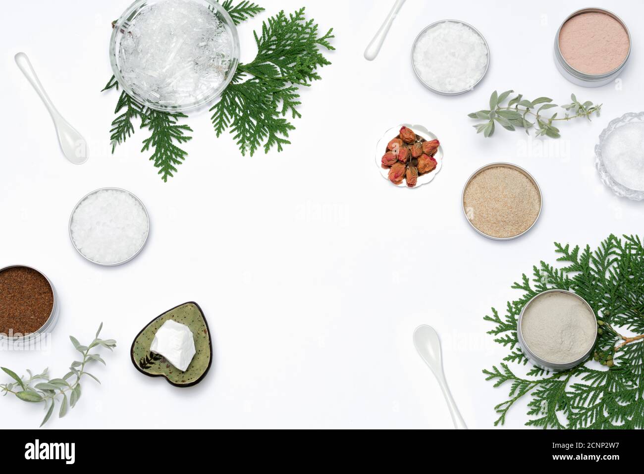 Ingredients for the production of cosmetics on a white background. Clays, wax, herbal powders, dried flowers, raspberry ketone, menthol crystals. Natural cosmetics concept. Stock Photo