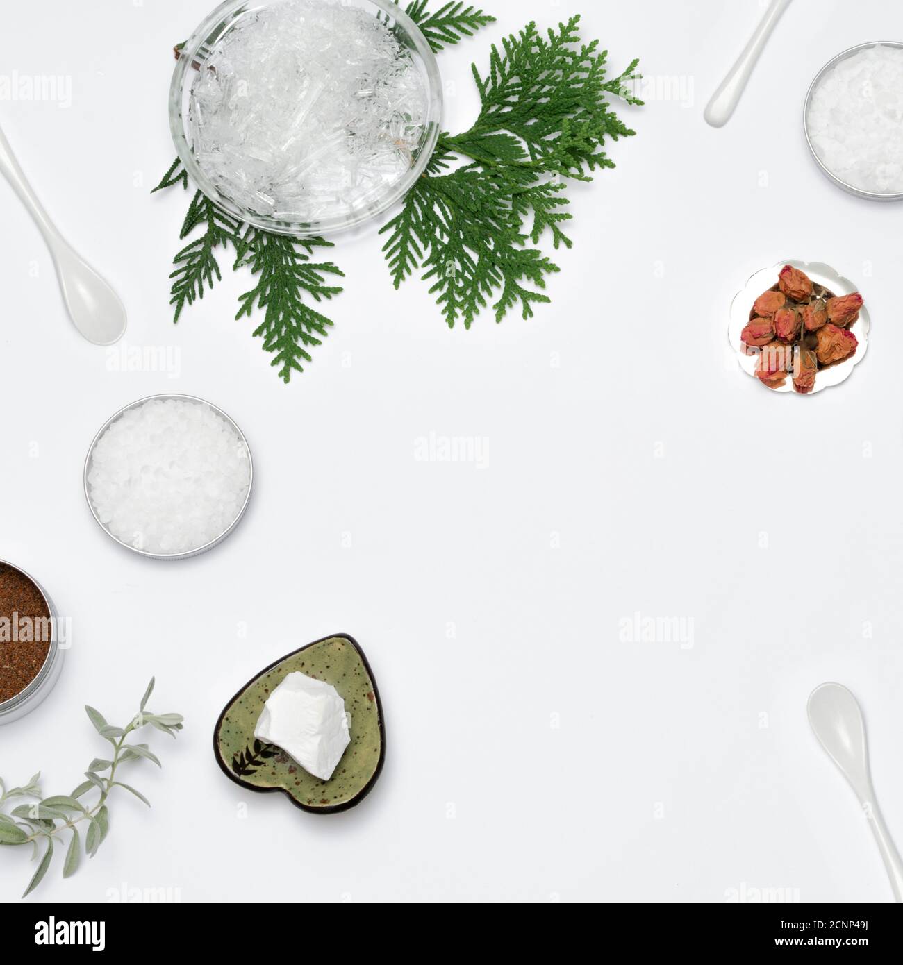 Ingredients for the production of cosmetics on a white background. Clays, wax, herbal powders, dried flowers, raspberry ketone, menthol crystals. Natural cosmetics concept. Stock Photo