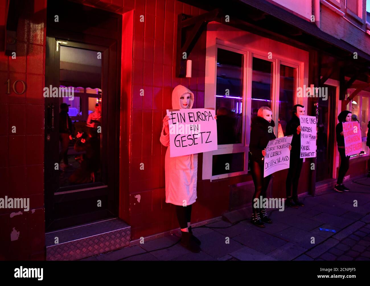 Prostitutes wearing masks hold reading "One Europe - One Law", "We attract your tourists, dear Germany" and "Without us more women and children will be violated", during a rally of prostitutes