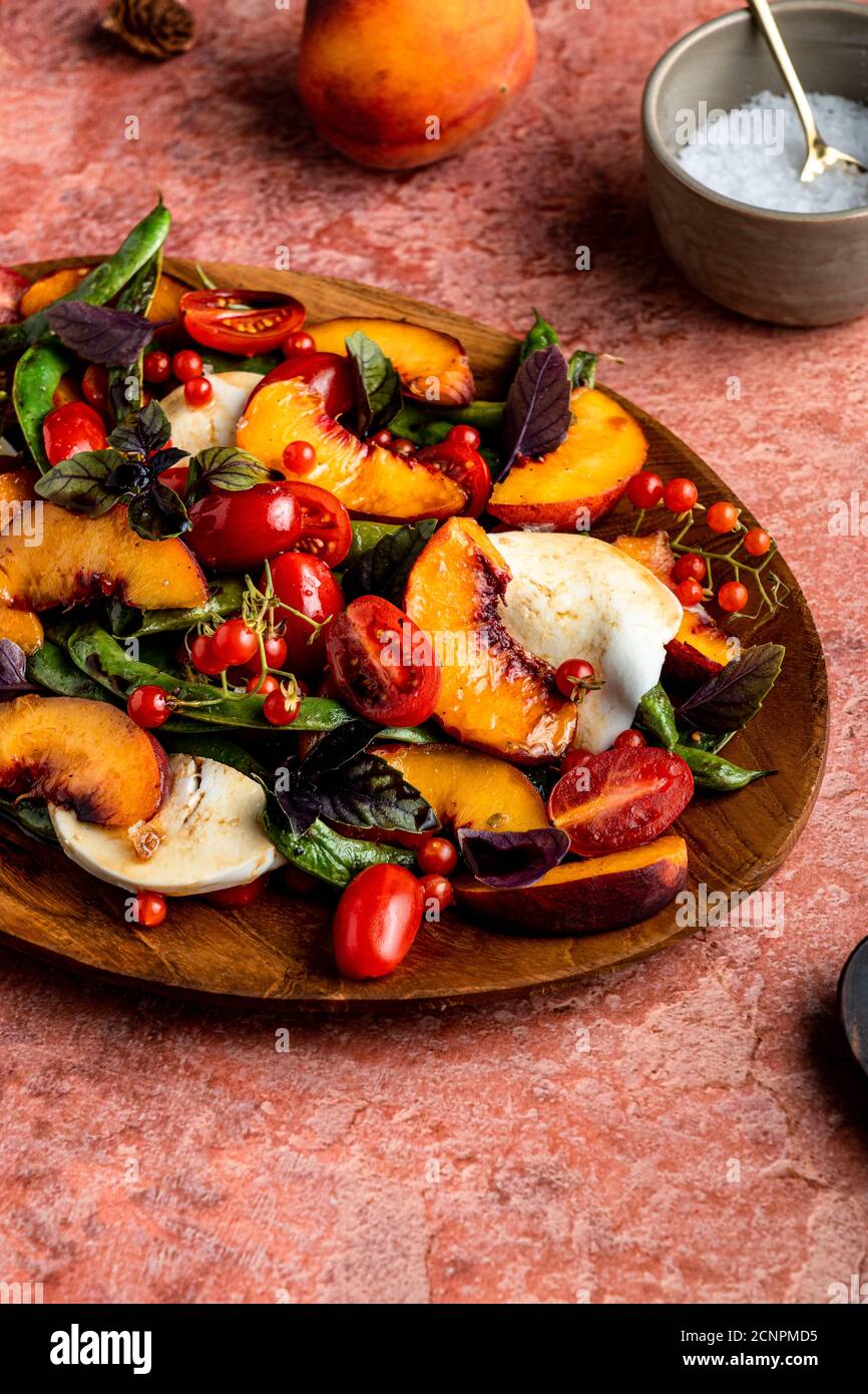 Vibrant, seasonal harvest caprese salad with juicy stone fruit. Stock Photo