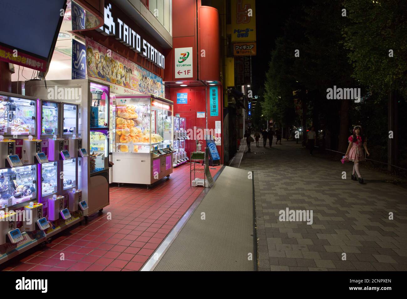 Tokyo, Japan. 17th Sep, 2020. An employee of a Maid Cafe walks past a Gaming Arcade in the famous electronics and Japanese pop culture district Akihabara. Credit: SOPA Images Limited/Alamy Live News Stock Photo