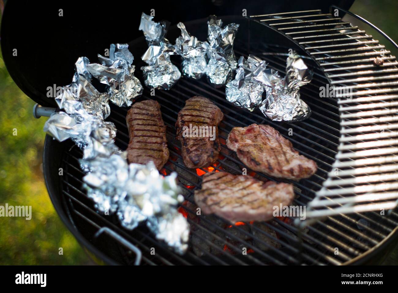 Grilling, meat, steaks, embers, grate, potatoes, foil, summer