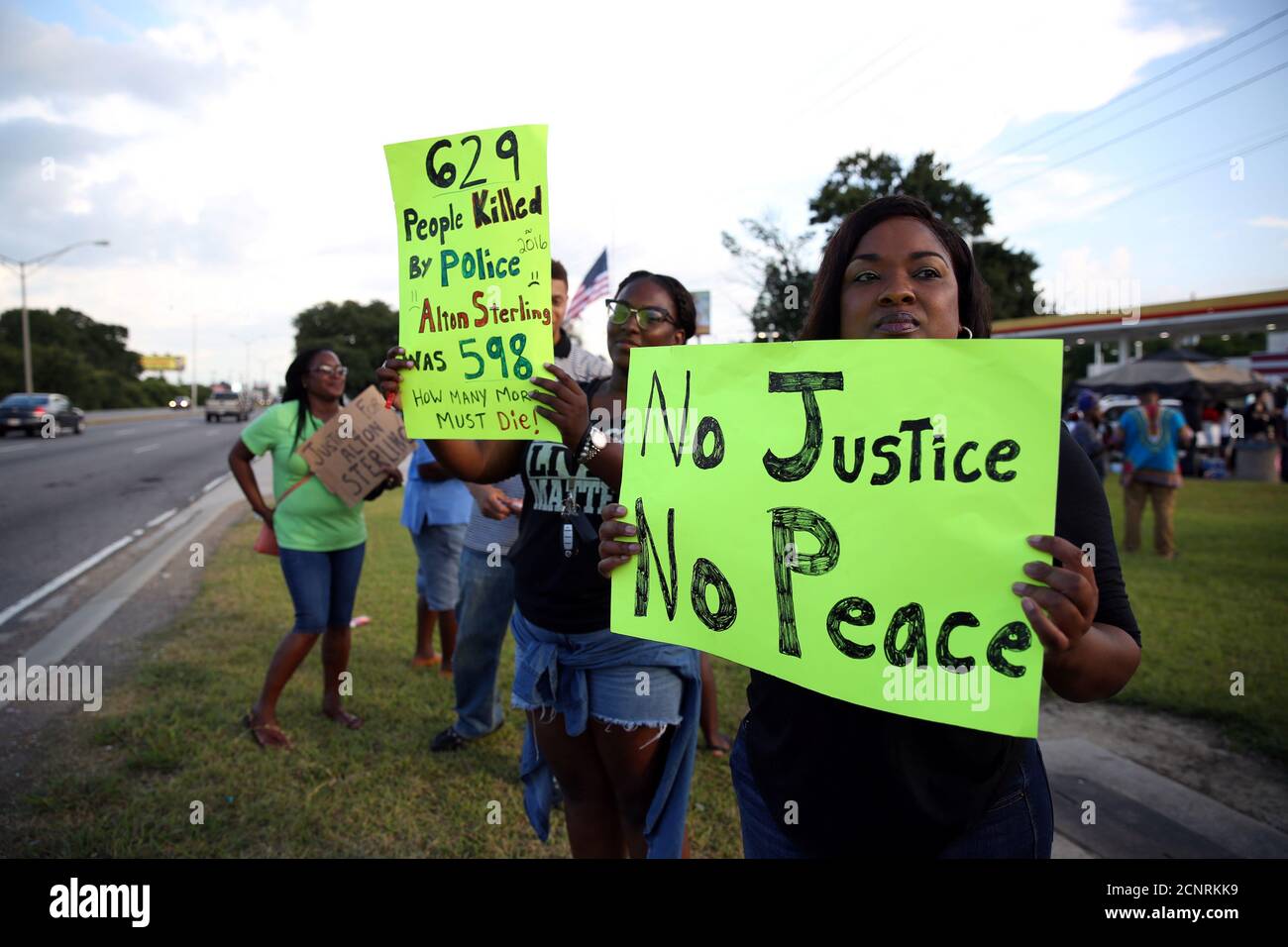 A woman holds a sign reading 'No justice, no peace,' as she protests the killing of Alton Sterling by police officers in Baton Rouge, Louisiana, U.S. July 16, 2016.  REUTERS/Joe Penney Stock Photo