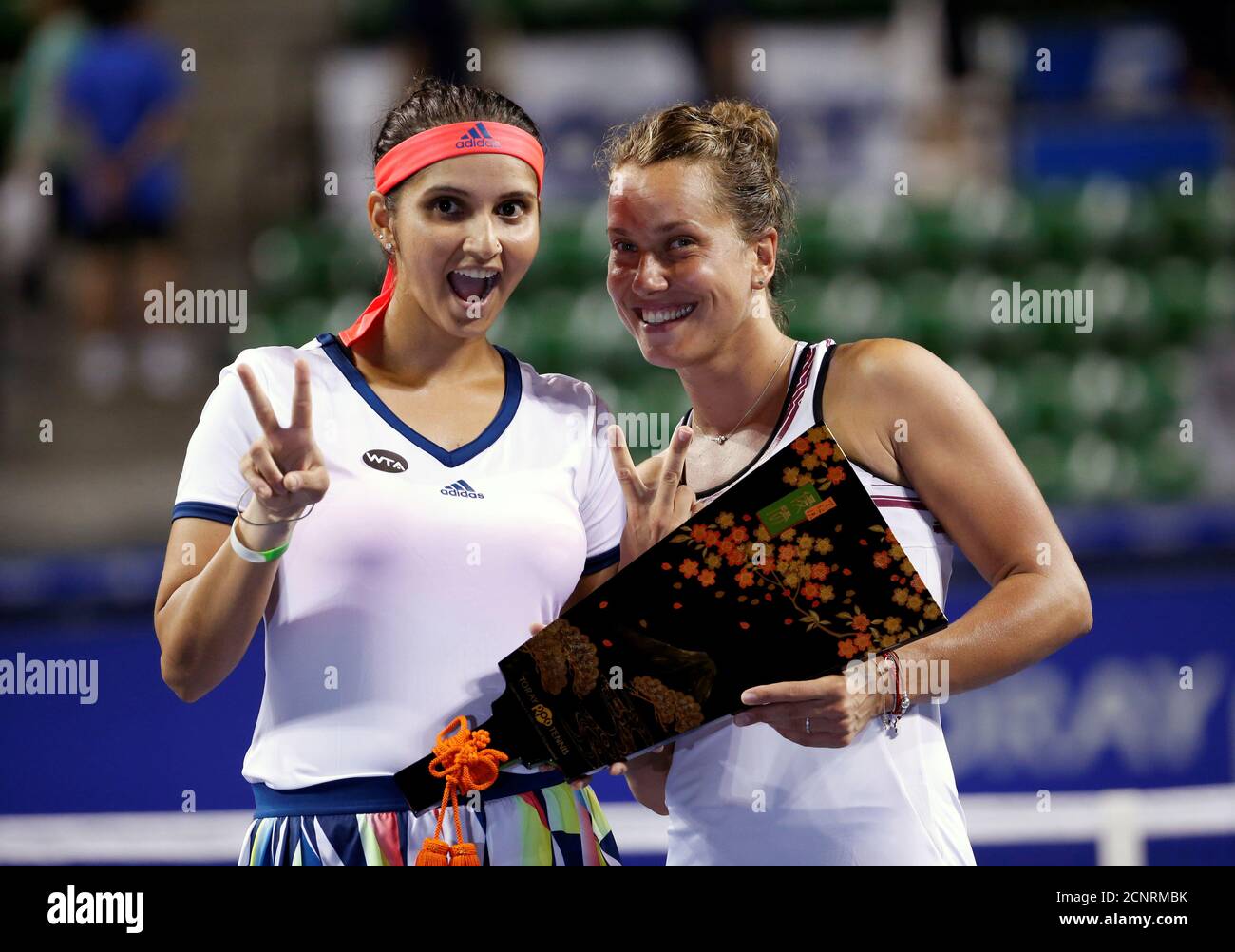 Tennis - Pan Pacific Open Women's Doubles Final match - Ariake Coliseum,  Tokyo, Japan - 24/09/16. Sania Mirza of India (L) and Barbora Strycova of  Czech Republic pose with their victory trophy.