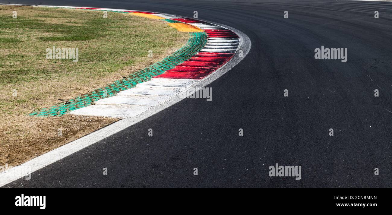 Speed concept, high angle view of asphalt racing circuit track turn white and red curb at border Stock Photo