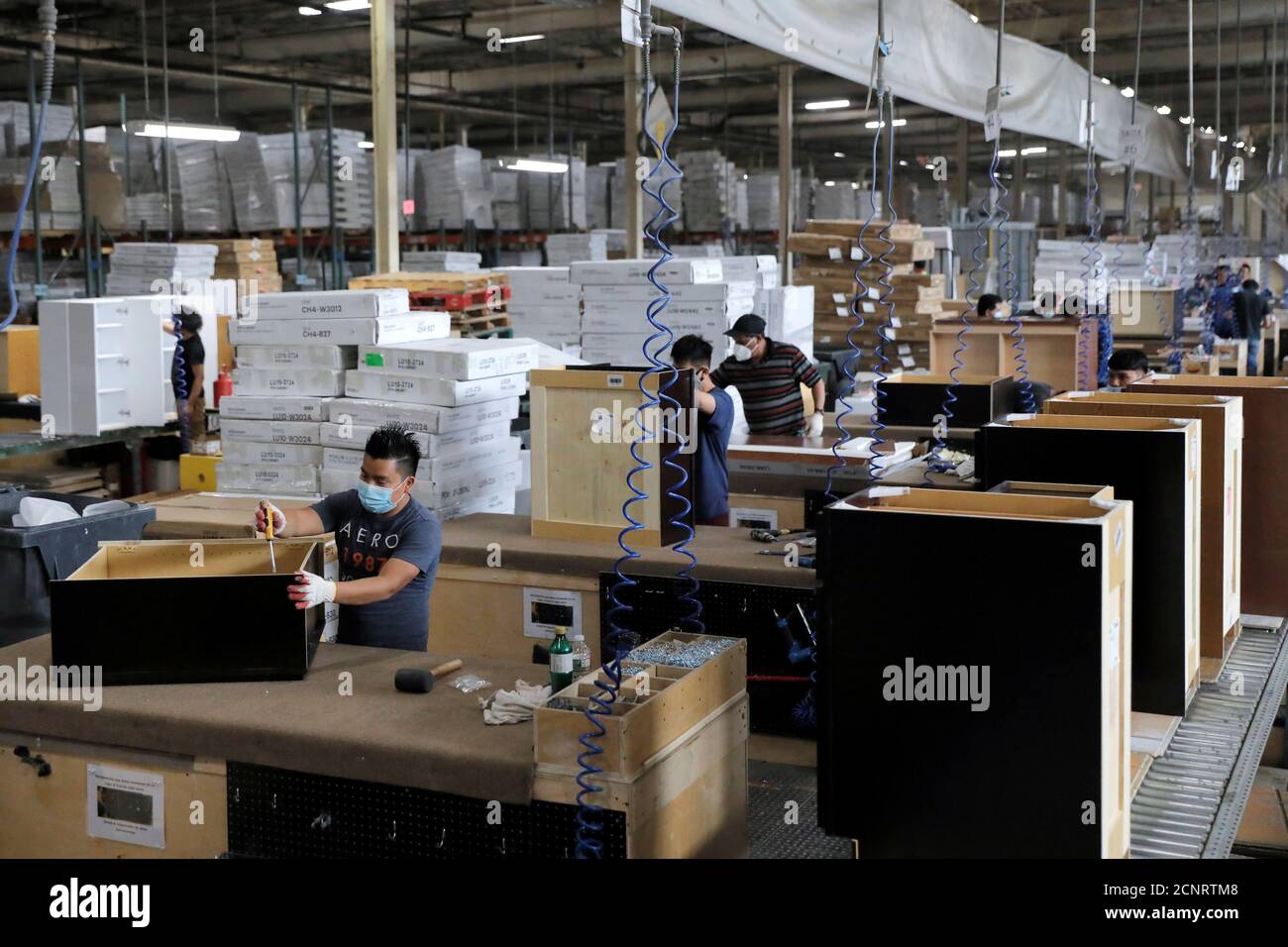 Workers assemble cabinets at CNC Cabinetry in South Plainfield, New Jersey, U.S., June 16, 2020. REUTERS/Andrew Kelly Stock Photo