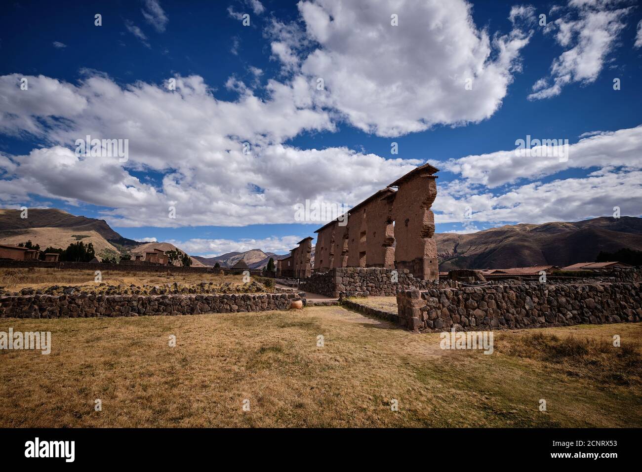 The Temple of Wiracocha at the Raqch'i Incan archaeological site, San Pedro District, Peru, shot against a striking blue sky with cloud Stock Photo
