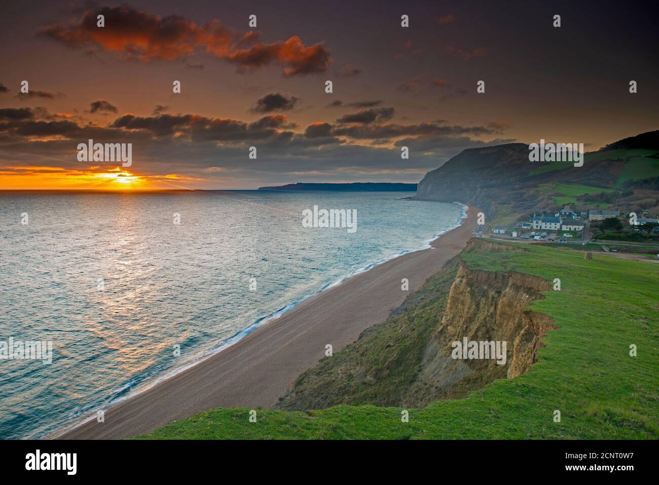 Sunset At Seatown With Views Of Golden Cap And Lyme Regis Dorset sunset-at-seatown-with-views-of-golden-cap-and-lyme-regis-dorset