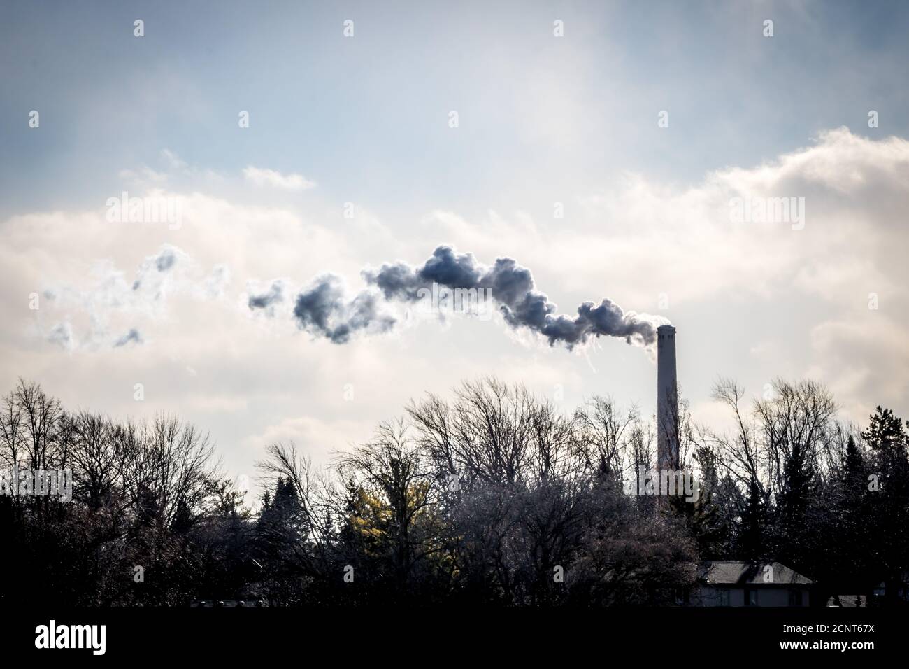 Smoke from a stack in winter Stock Photo