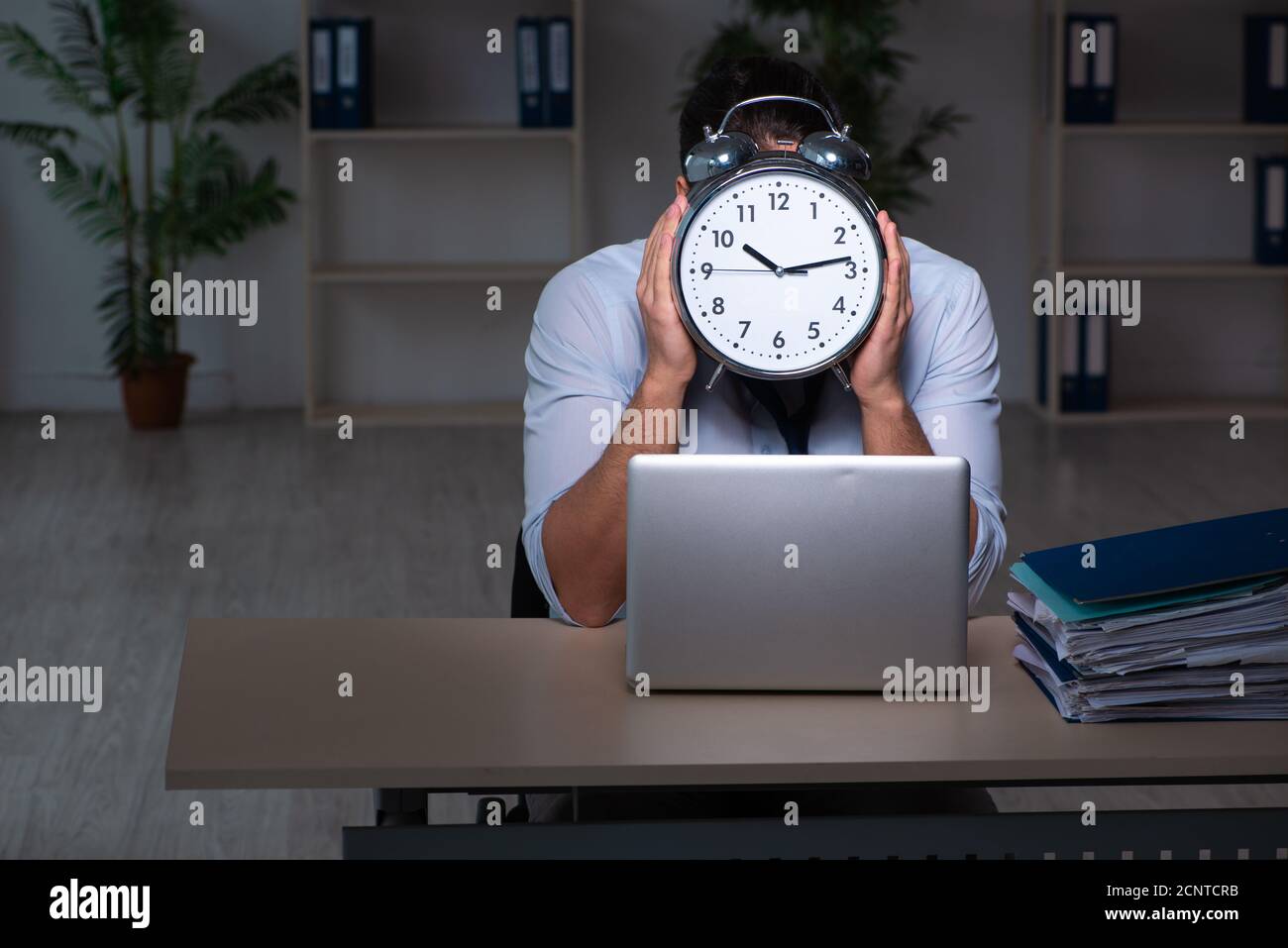 Young businessman working late in the office workplace Stock Photo - Alamy