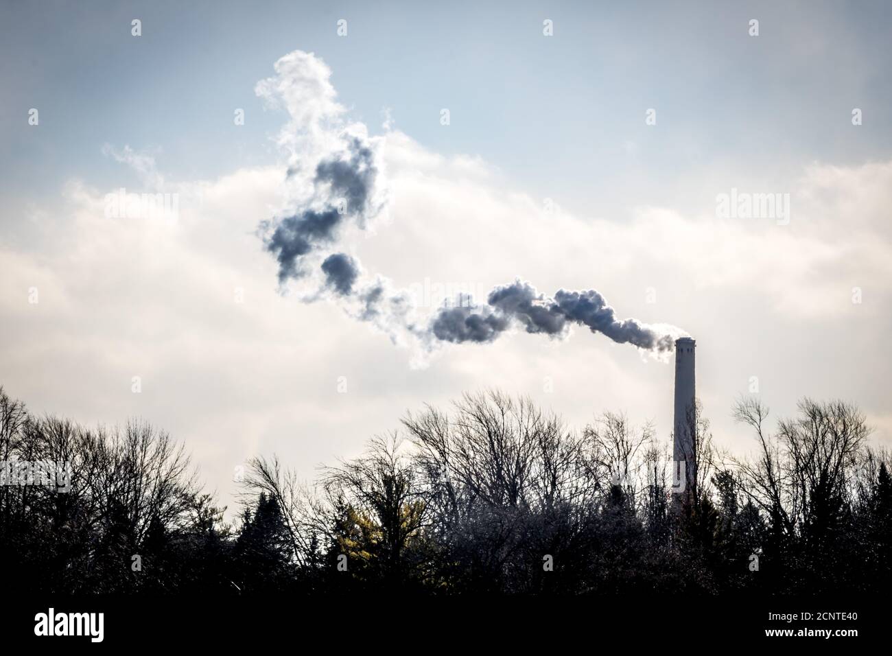 Smoke from a stack in winter Stock Photo
