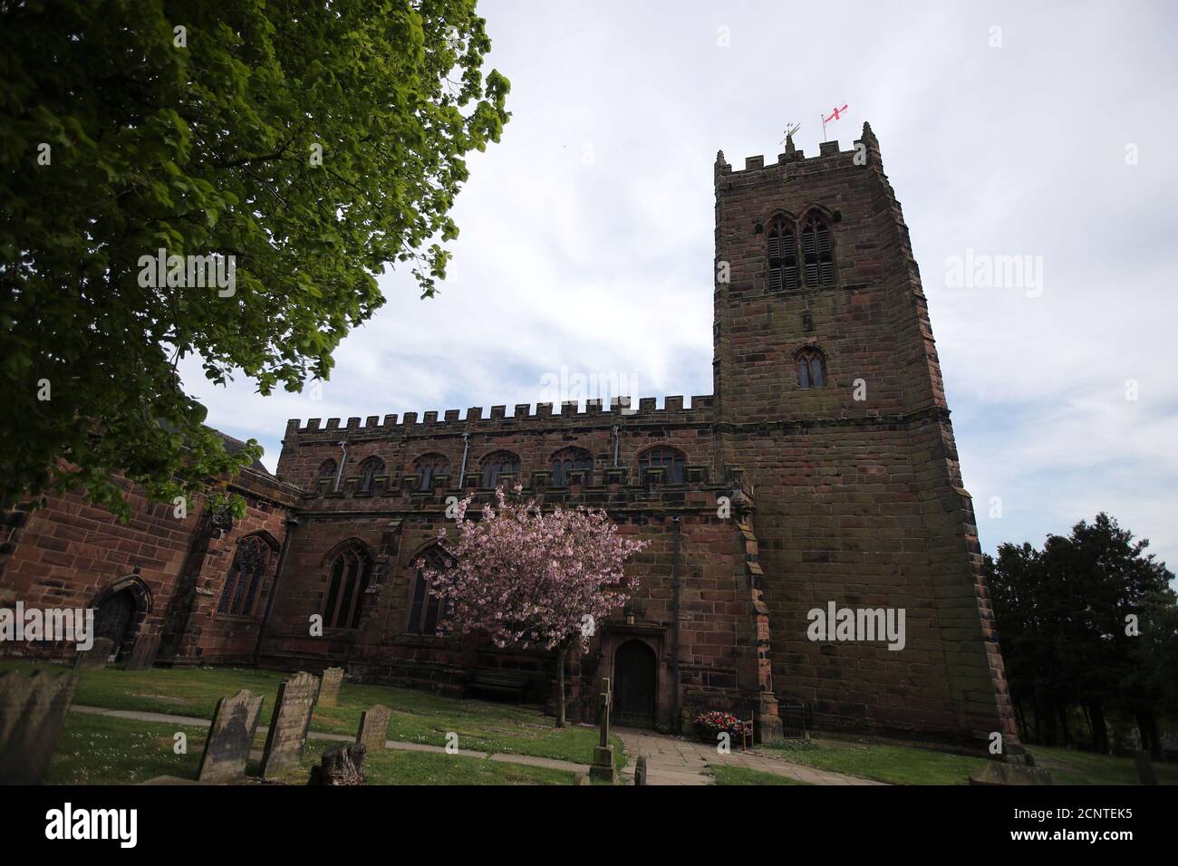 A St. George's flag flutters on a church, as the spread of the coronavirus disease (COVID-19) continues, in Great Budworth, Britain April 23, 2020. REUTERS/Molly Darlington Stock Photo