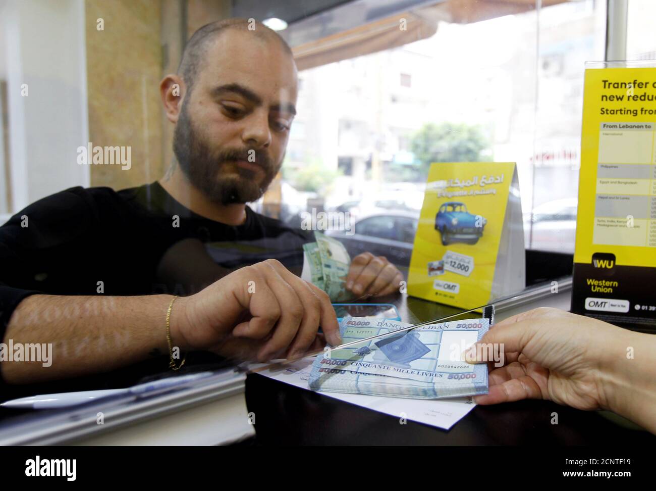 A man takes Lebanese pound banknotes at the money transfer offices of Western  Union and OMT in Beirut, Lebanon April 24, 2020. REUTERS/Mohamed Azakir  Stock Photo - Alamy