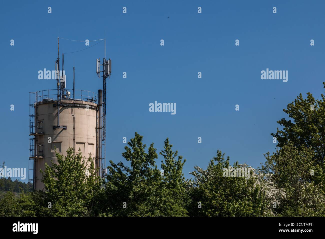 Antennas on a small tower in the center of the town Stock Photo