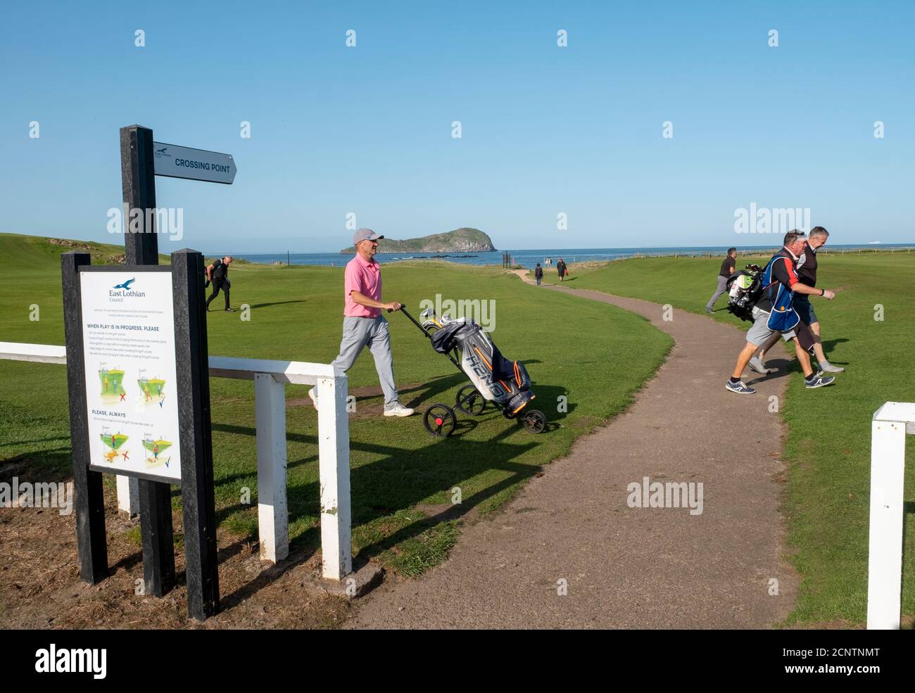 Golfers walk down the18th fairway at the West Links golf course, North Berwick, East Lothian, Scotland. Stock Photo