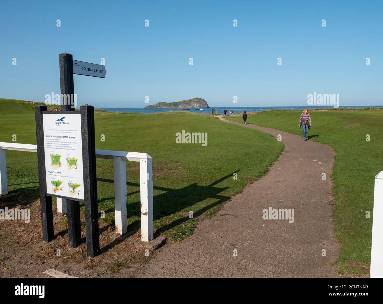 Golfers walk down the18th fairway at the West Links golf course, North Berwick, East Lothian, Scotland. Stock Photo
