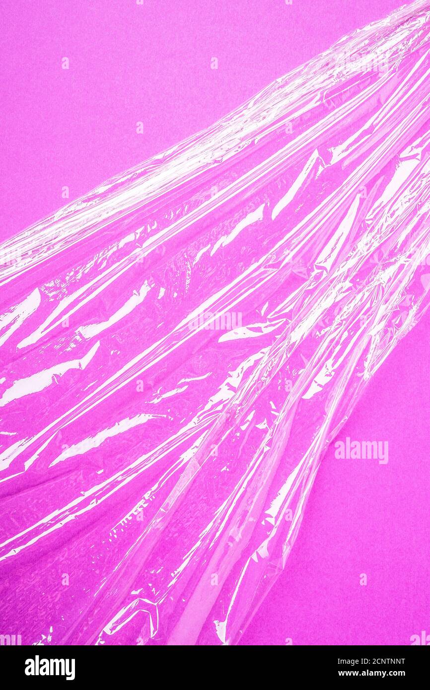 Stretch wrap plastic on pink background, minimalistic creative layout, ecology and environment concept Stock Photo