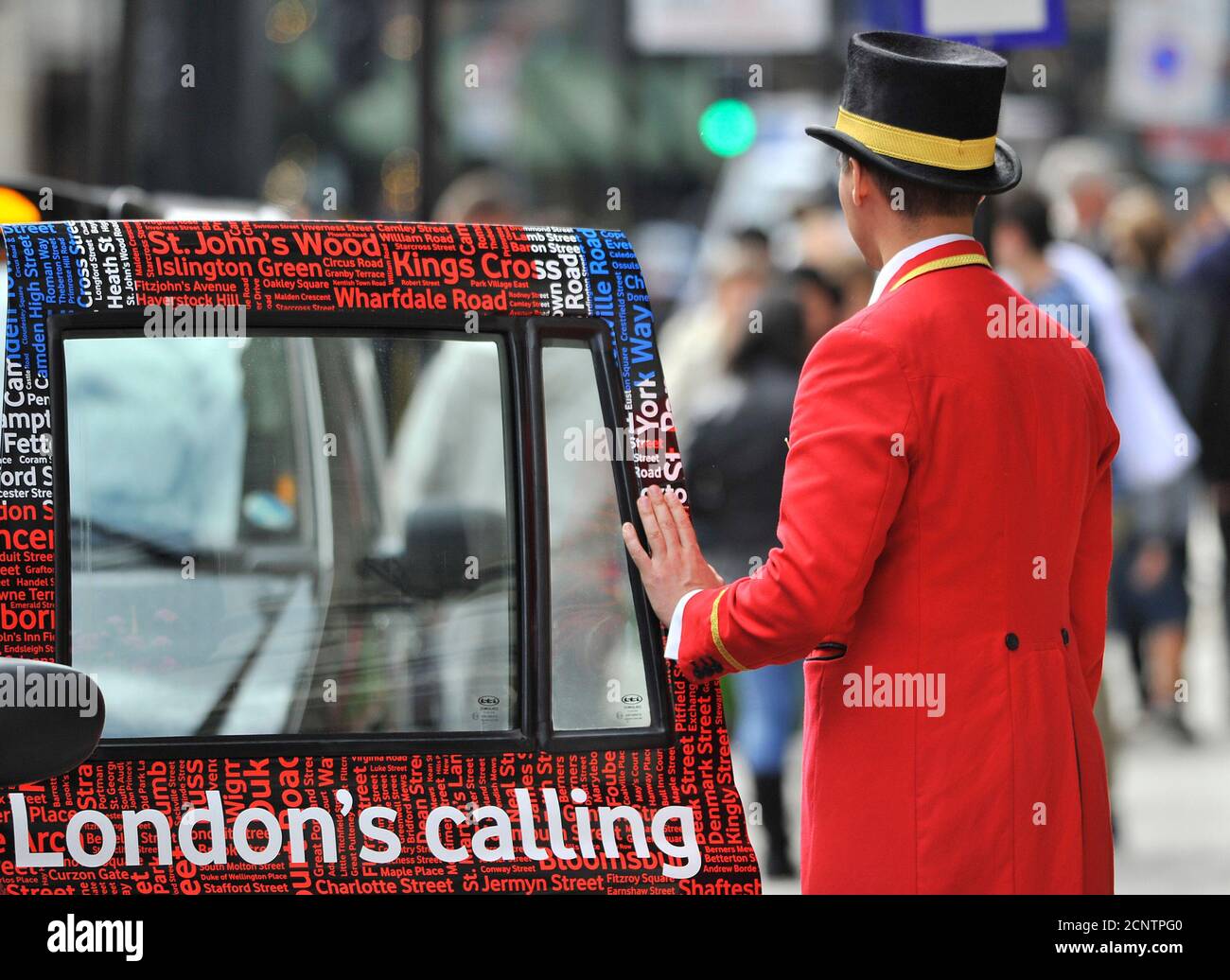 A doorman closes a taxi door outside a hotel in central London September 5, 2011. Activity in the dominant services sector slowed at the fastest pace in a more than a decade last month, and firms' confidence in future business weakened to a one-year low, adding to evidence of a stalling economic recovery.     REUTERS/Toby Melville (BRITAIN - Tags: BUSINESS EMPLOYMENT TRAVEL) Stock Photo