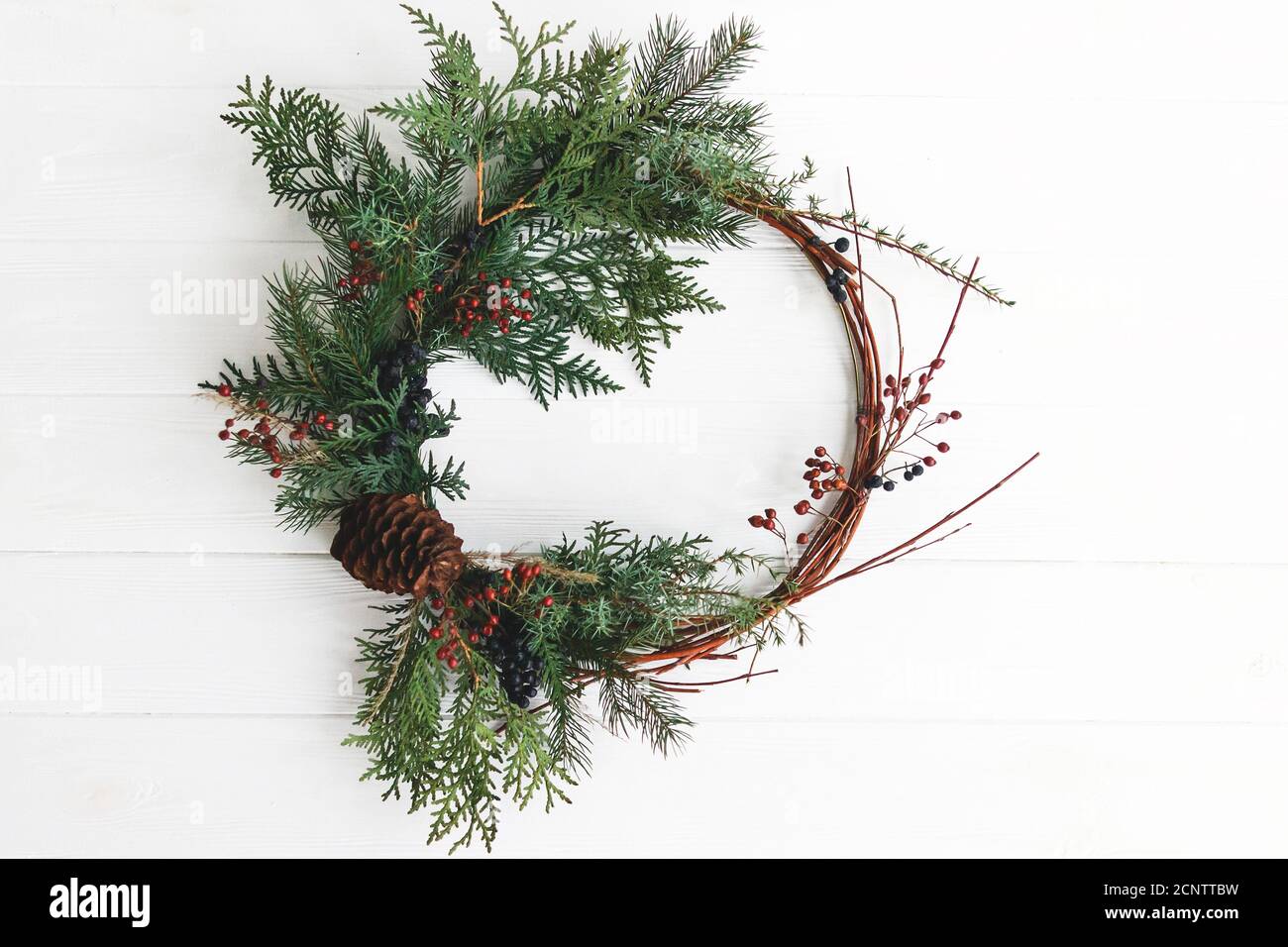 Creative modern christmas wreath with red berries and fir branches ...