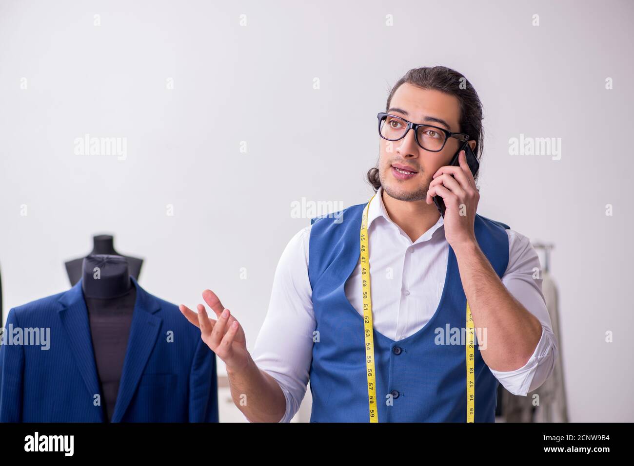 Young tailor working at workshop Stock Photo