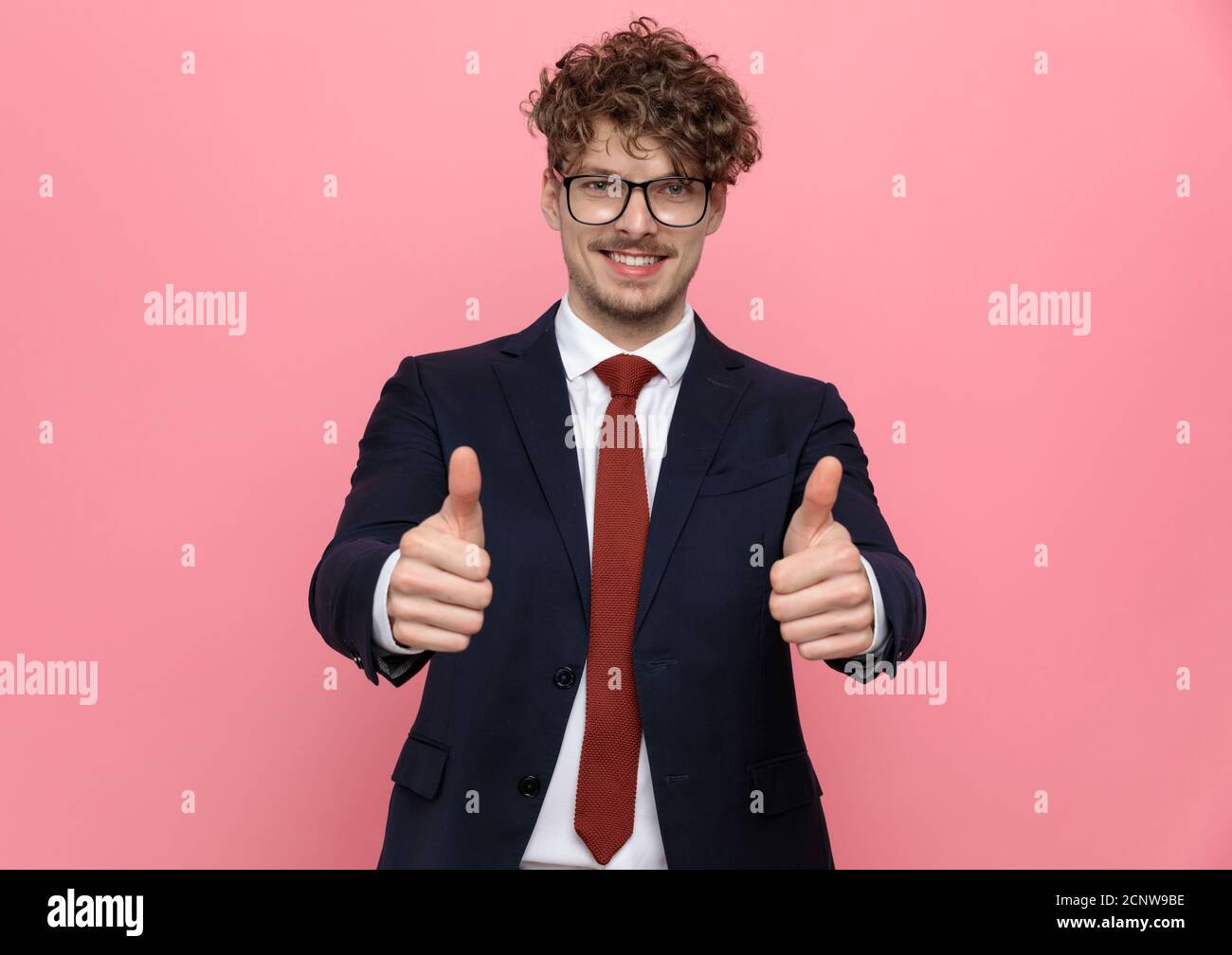 happy young businessman in navy blue suit wearing eyeglasses and making ...