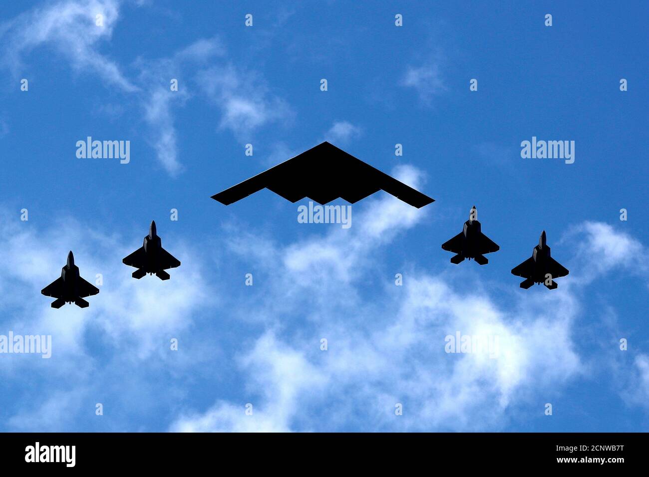 A U.s. Air Force B-2 Spirit Stealth Bomber (C) Is Flanked By 4 U.s. Marine  Corps F-35 Fighters During A Flyover Of Military Aircraft Down The Hudson  River And New York Harbor