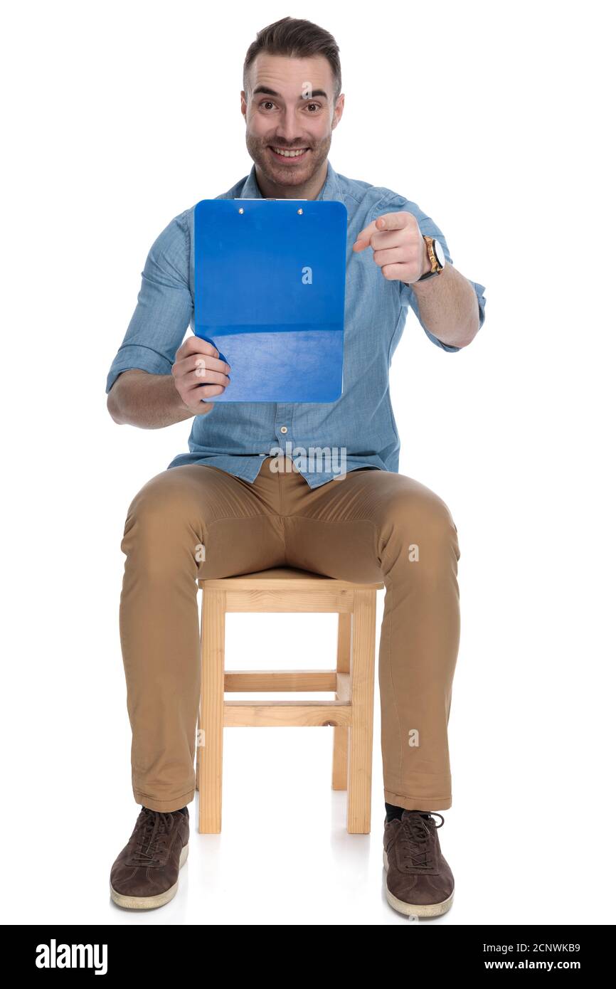 Seated man reading clipboard hi-res stock photography and images - Alamy