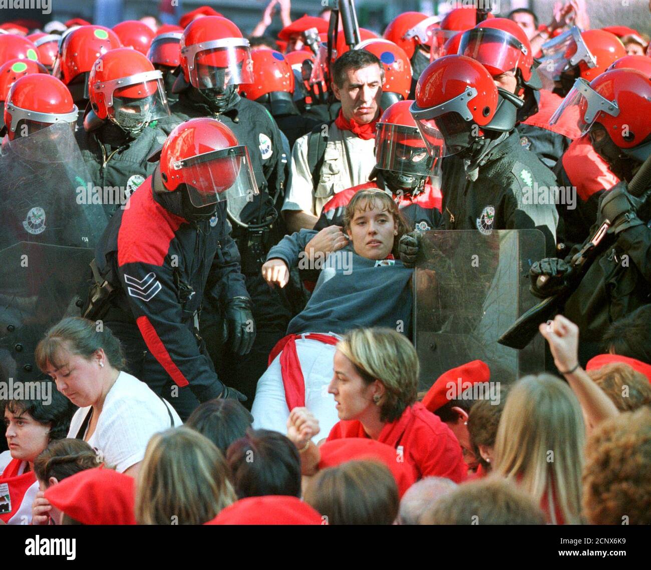 Basque policemen detain a group of women blocking a road during a march of traditionalists in the town of Hondarribia September 8, 2000. Police detained over 20 women. Traditionalist groups succeeded in preventing the participation of women in the all-male 'Alarde', a yearly parade celebrating an ancient war against French soldiers.  ES Stock Photo