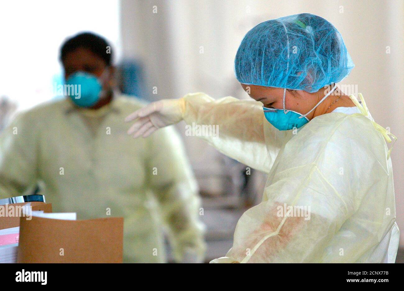 A Nurse Works At Tan Tock Seng Hospital S Sars Screening Tent In Singapore September 9 2003