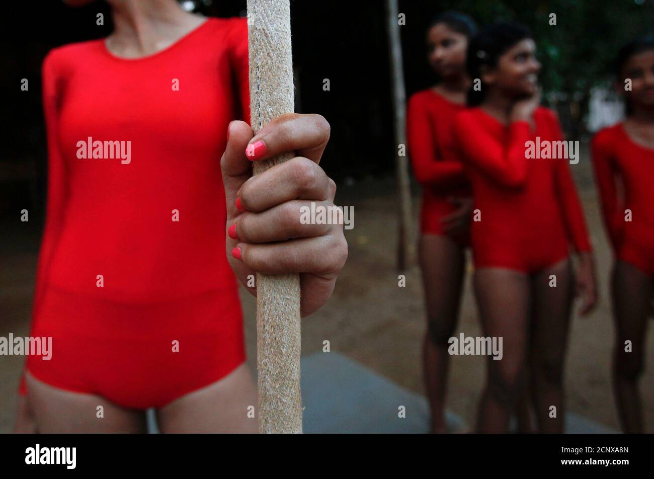 A girl with painted fingernails holds onto a rope before performing a  Mallakhamb pose at the Shree Samartha Vyayam Mandir in Mumbai, October 19,  2012. Mallakhamb is an ancient Indian sport which