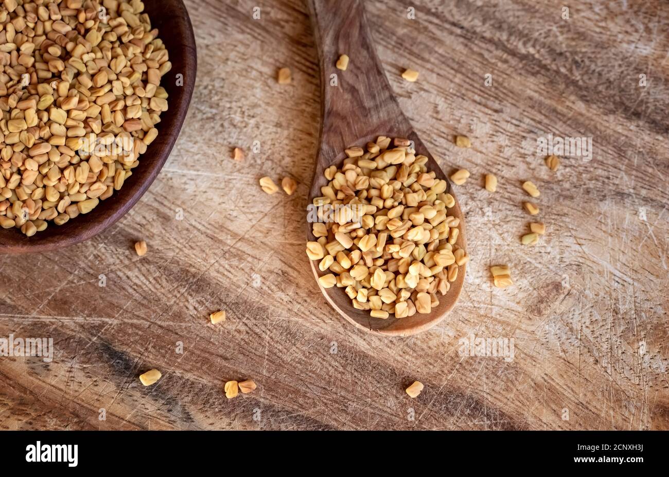 Fenugreek seeds on a spoon, top view. Stock Photo
