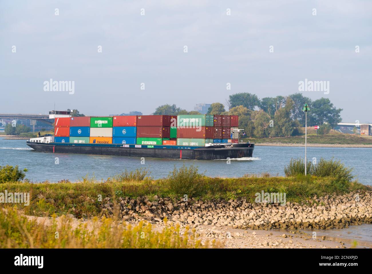 NIJMEGEN, NETHERLANDS - SEPTEMBER 12, 2020: Container ship on the Waal river heading to Germany Stock Photo